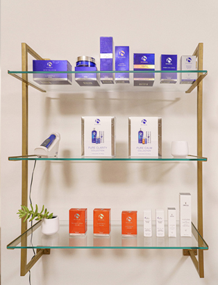 Product shots of skincare on a golden shelf 