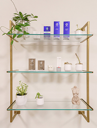 Product shots of skincare on a golden shelf 