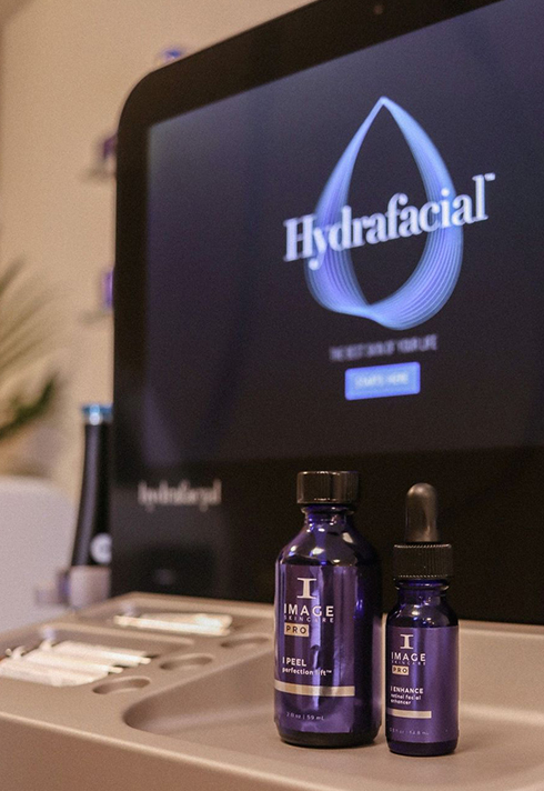 Hydrafacial machine with blue bottle skincare products