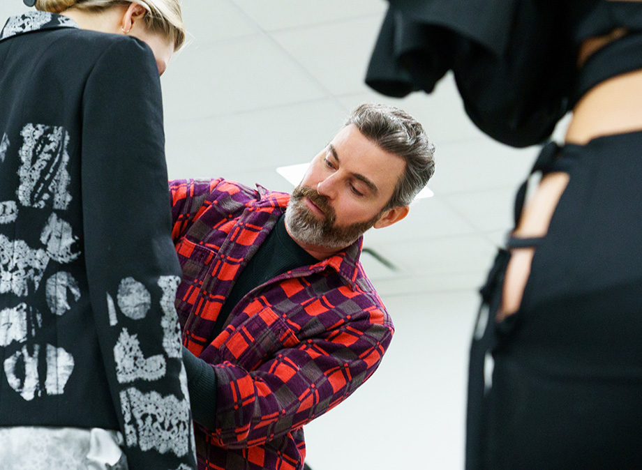 Tyler Udall fixing Marc Jacobs runway garments at the backstage.
