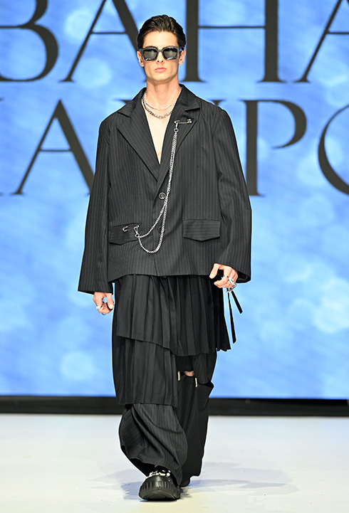 A Caucasian male model wearing black garment designed by Bahar Kianpour at Vancouver Fashion Week 2024