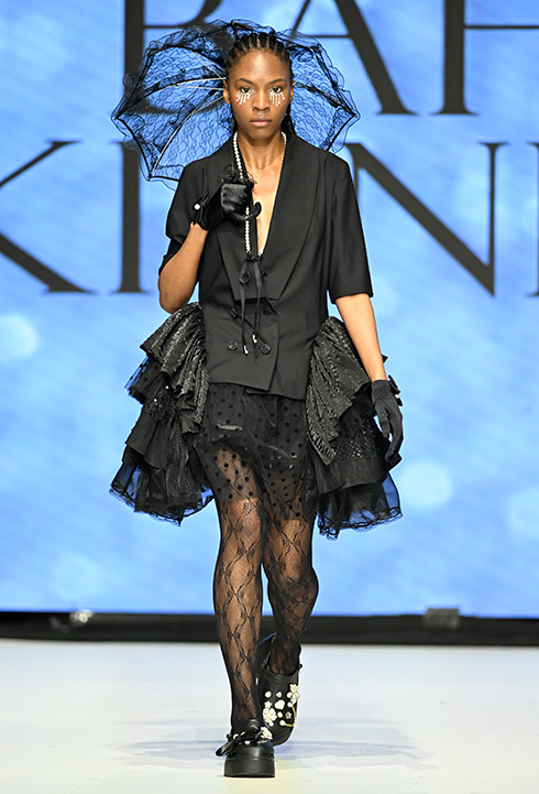 An African American female model wearing black garment designed by Bahar Kianpour at Vancouver Fashion Week 2024